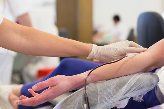 Role of nurses in blood services and donor sessions.  Nurse and blood donor at donation.