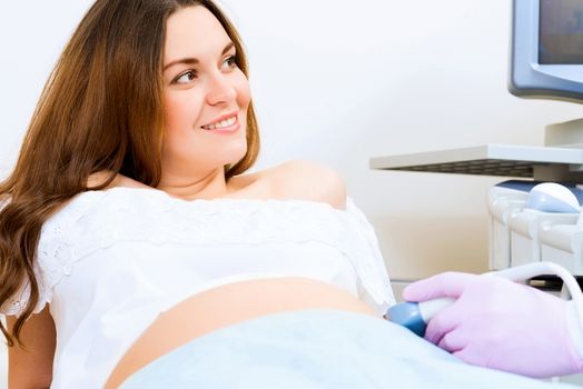 Young attractive pregnant woman on reception at the doctor, health check