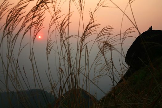 Single person silhouette and sunset at mountain, Kanjaburi, Thailand.