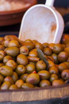 Wooden drums with olives and variants