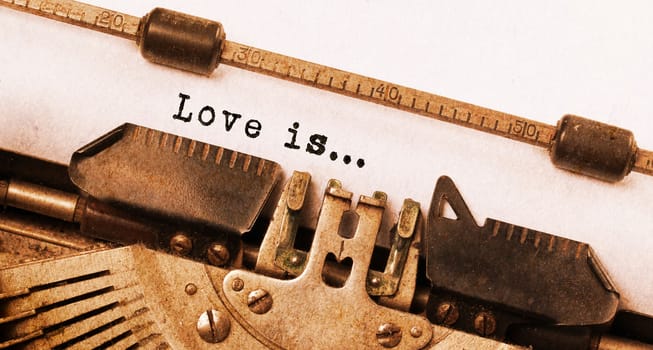 Vintage inscription made by old typewriter, love is