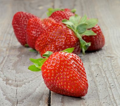 Arrangement of Big Fresh Ripe Strawberries isolated on Rustic Wooden background