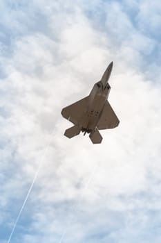 military stealth fighter speeding through the sky