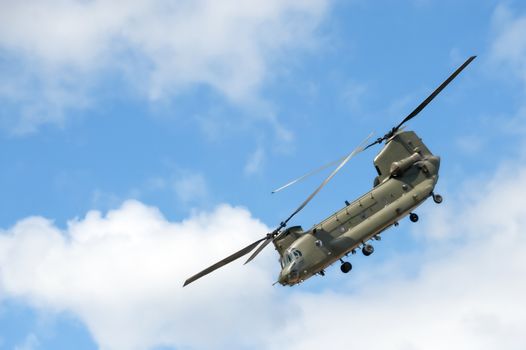 military helicopter in a steep flight maneuver