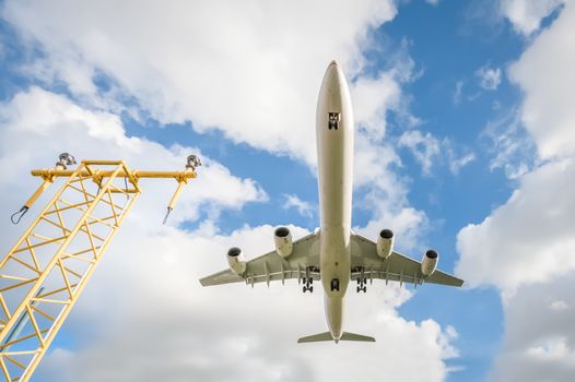 wide-angle view of a passenger jet landing at an airport