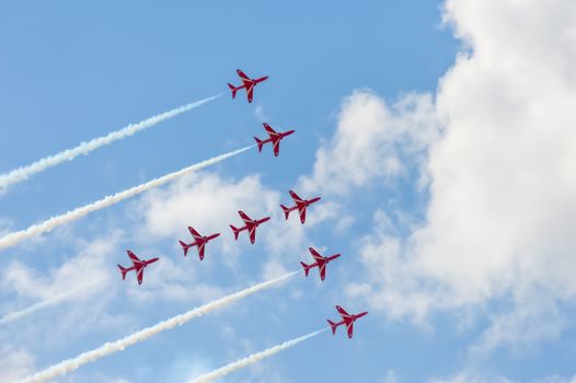 Farnborough, UK - July 15, 2010: Precision maneuver by the Red Arrows aerobatic display team during the Farnborough International Airshow,  UK