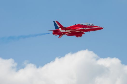 Farnborough, UK - July 15, 2010: Low level pass by a Red Arrows aerobatic display jet during the Farnborough International Airshow, UK