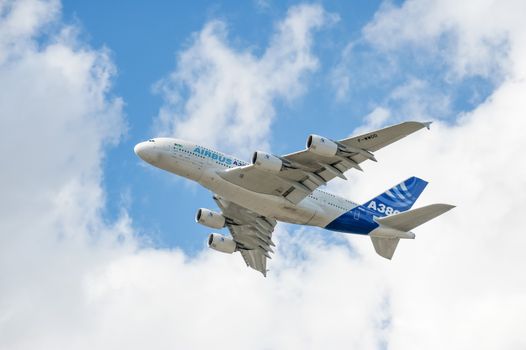 Farnborough, UK - July 16, 2010: Airbus A380 climbing through clouds during the Farnborough Airshow, UK