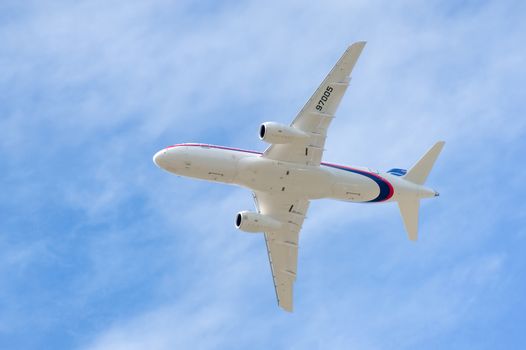 Farnborough, UK - July 20, 2010: Russian developed Sukhoi Superjet 100-95 passing overhead at the Farnborough Airshow, UK