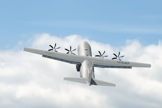 Farnborough, UK - July 24, 2010: USAF Hercules C-130J military cargo transporter making a steep display take-off at the Farnborough Airshow, UK