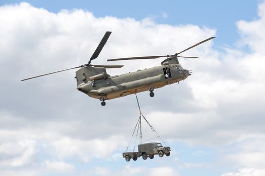 Farnborough, UK - July 24, 2010: RAF Chinook helicopter in vehicle lift demonstration at the Farnborough Airshow, UK