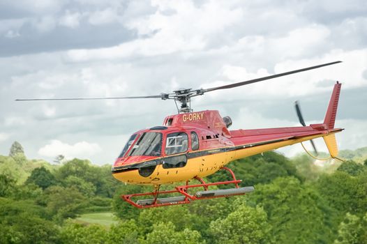 London, UK - May 14, 2011: The popular GORKY tourist helicopter ferrying passengers over the lush countryside surrounding the city of London, UK