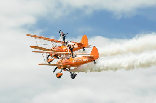 Farnborough, UK - July 15, 2012: Breitling Wingwalkers aerobatic and gymnastic formation display team performing at the Farnborough Airshow, UK