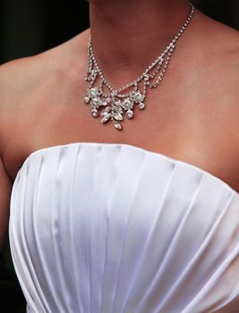 Wedding diamond necklace on a neck of the bride