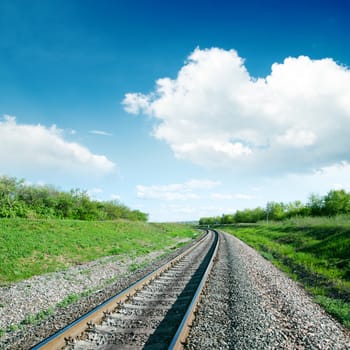 white clouds over railroad