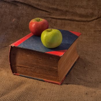 books and apple on  table