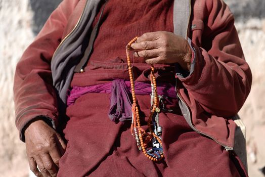 Prayer beads in monk's hand