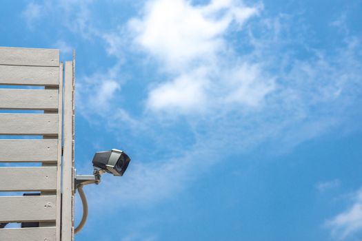 cctv security camera at  wall corner on blue sky scene