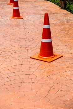 orange plastic cone sign on concrete floor