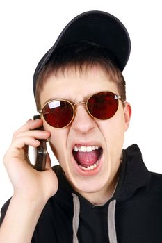 Angry Teenager in the Cap calling on Cellphone on the White Background