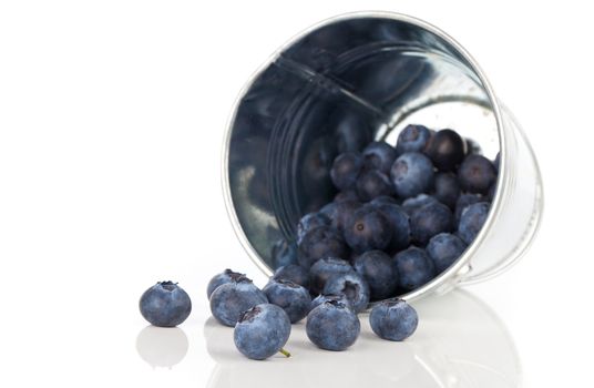 blueberry berries in a metal bucket, isolated on white background