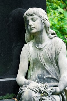 The stone Girl on Tomb from the old Cemetery, parish of Mary Magdalene in Weimar, Germany