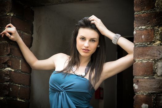 Elegant attractive young woman on threshold looking at camera