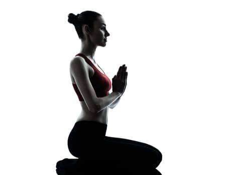 one  woman exercising yoga meditating in silhouette studio isolated on white background