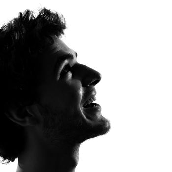 young man looking up smiling happy portrait silhouette in studio isolated on white background