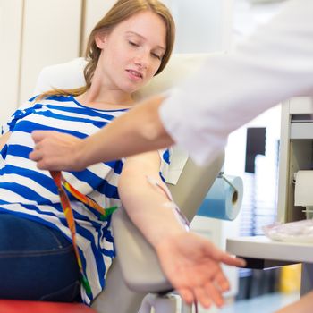 Role of nurses in blood services and donor sessions.  Nurse and blood donor at donation.