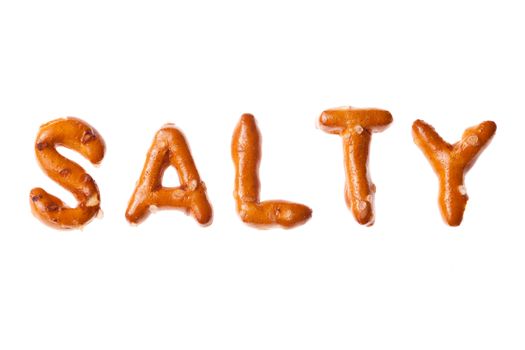 Word SALTY written, laid-out, with crispy alphabet pretzels isolated on white background