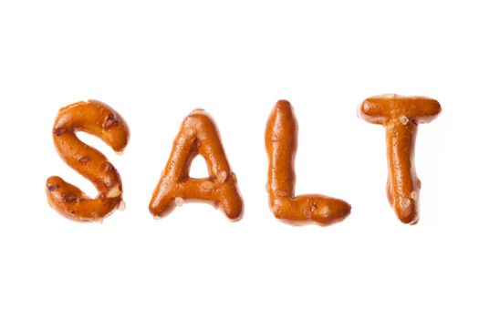 Word SALT written, laid-out, with crispy alphabet pretzels isolated on white background