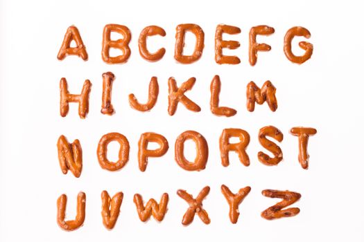 Whole alphabet written, laid-out, with crispy alphabet pretzels isolated on white background