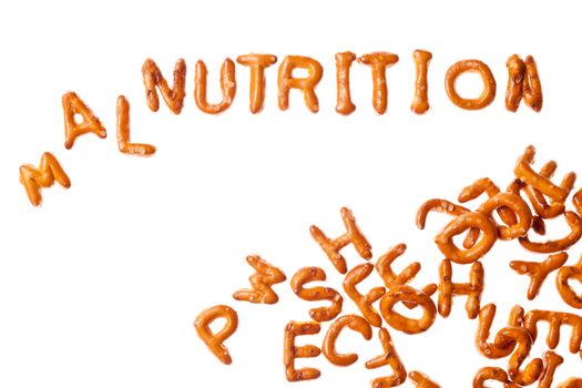 Word NUTRITION written, laid-out, with crispy alphabet pretzels and a group of them isolated on white background