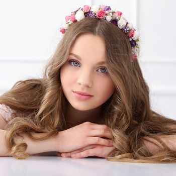 Cute, young girl with flowers at head