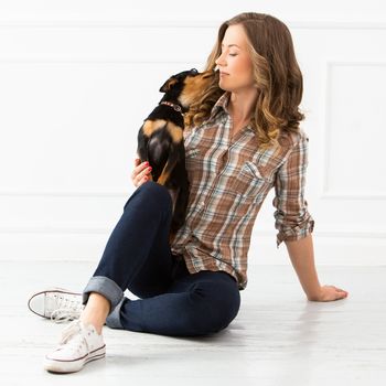 Attractive woman with dog on the floor