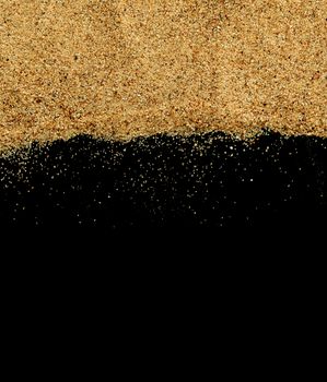 The sand on the black background close-up