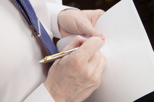 Businessman holding a list of paper and pen