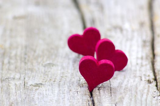 red hearts on wooden background