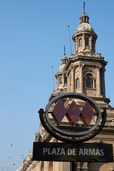 Metro Station at the Plaza de Armas in Santiago, Chile with the ornate facade of the historic Catedral Metropolitana in the background.