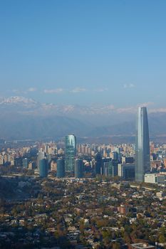 Modern office and apartment blocks of Santiago in Chile against the backdrop of the snow capped mountains of the Andes.
