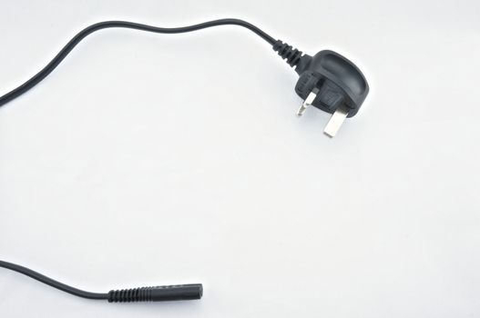 Black three-prong plug on white background. Line a standard and save