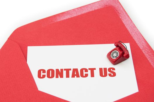 Contact us business card inside an open envelope with a small phone on one side 