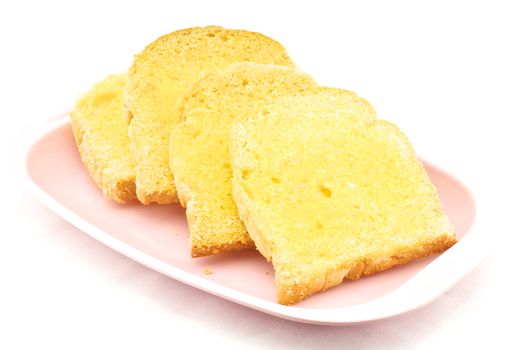 Bread baked with butter and sugar placed in a pink tray on white background.