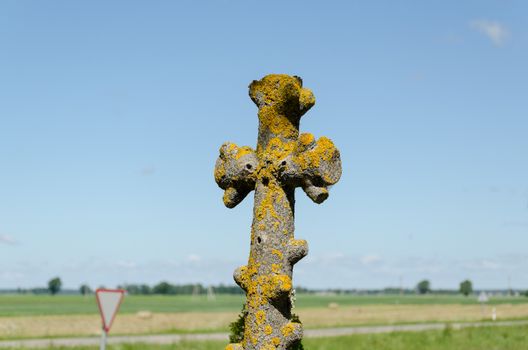 old antique mossy metallic cemetery cross outdoor