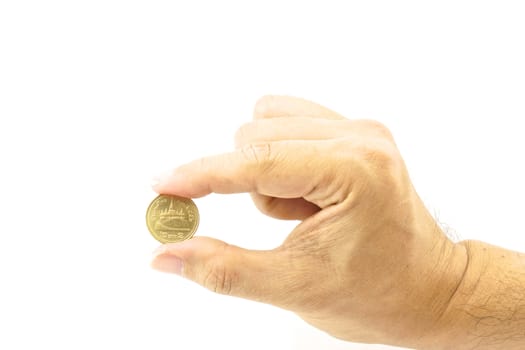 Hand of man holding gold coin on the white background.