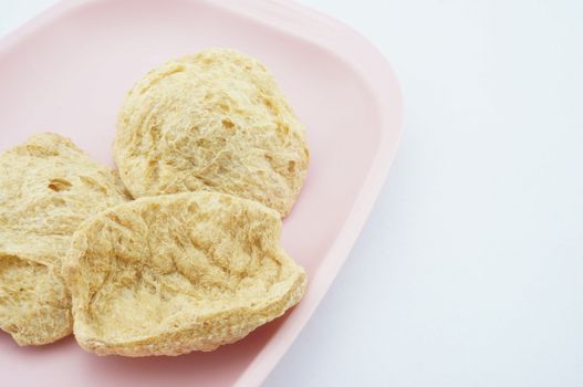 Vegan Protein Dry placed on pink tray with white background.