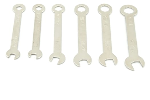 Multi sizes of Wrench use for minor repair arranged on white background.