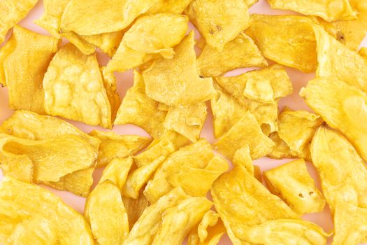 Sliced yellow cassava fried and coating sugar paste as background.