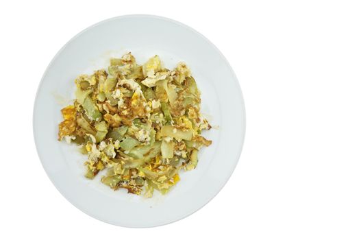 Chayote sliced fried with egg on white dish with white background.